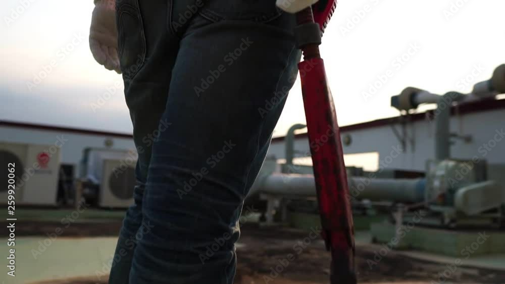 Concept Labor Day: Labor man holding a pipe wrench with the warm light of the Sunset footage slow motion Concept Labor Day: Labor man holding a pipe wrench with the warm light of the Sunset footage slow motion