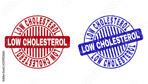 Grunge LOW CHOLESTEROL round stamp seals isolated on a white background. Round seals with grunge texture in red and blue colors.