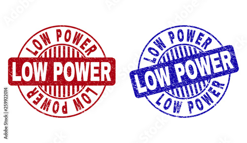 Grunge LOW POWER round stamp seals isolated on a white background. Round seals with grunge texture in red and blue colors. Vector rubber imprint of LOW POWER title inside circle form with stripes.