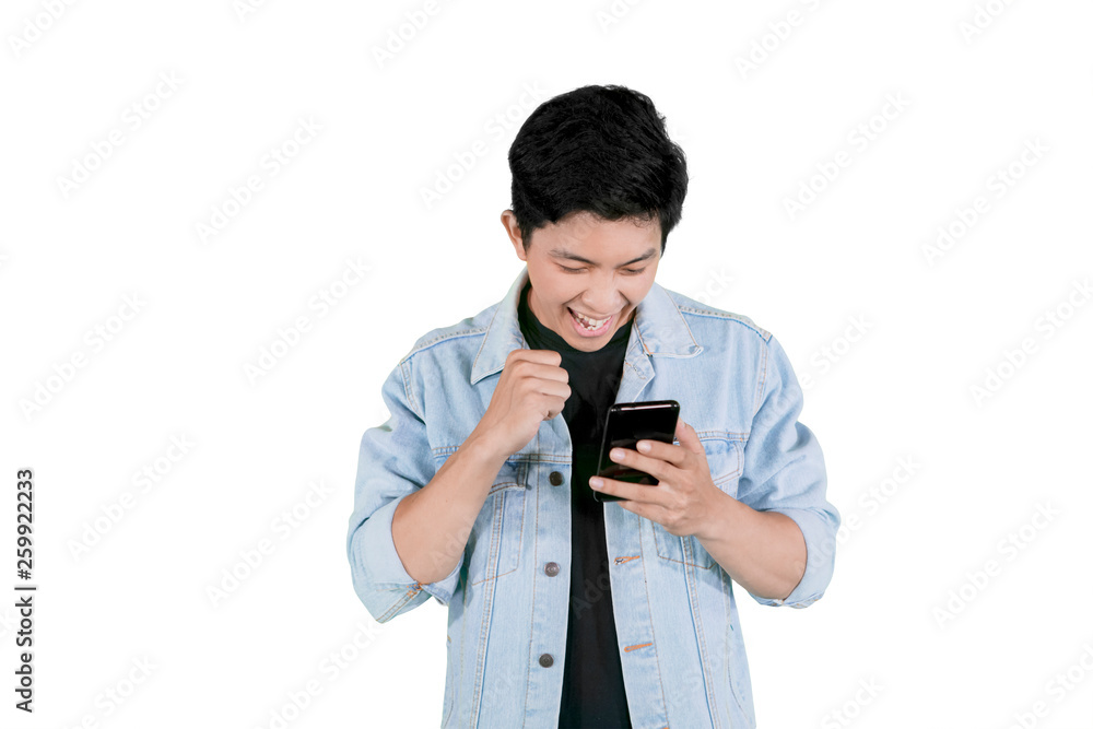 Asian man gets a good news on the smartphone Asian man gets a good news on the smartphone