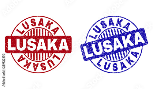 Grunge LUSAKA round stamp seals isolated on a white background. Round seals with grunge texture in red and blue colors. Vector rubber imprint of LUSAKA title inside circle form with stripes.