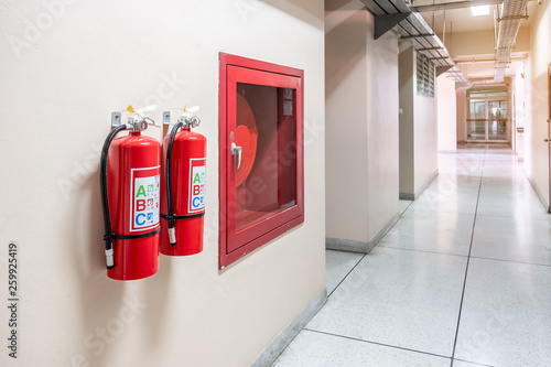 Fire extinguisher system on the wall background, powerful emergency equipment for industrial photo