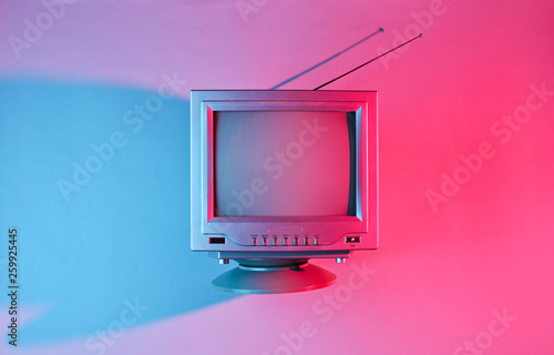 Retro wave, 80s. Old tv with antenna with neon light. Top view, minimalism photo