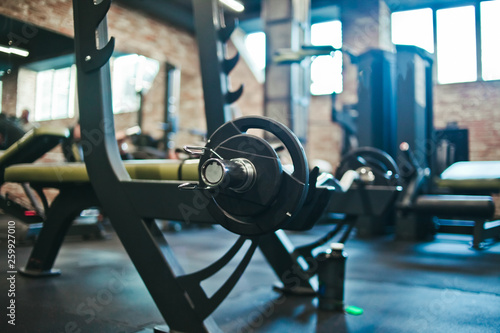 Gym equipment. Dark Gym with barbells on rack. Fitness workout center. Sport concept.