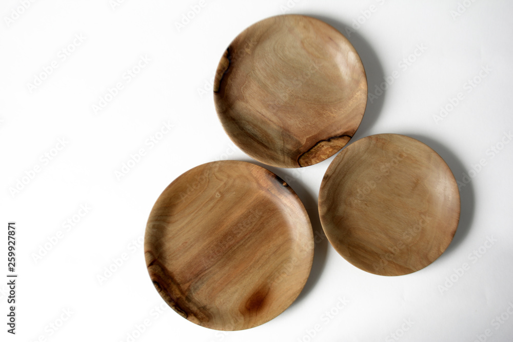 Empty wooden plates on a light background with spikelets Empty wooden plates on a light background with spikelets