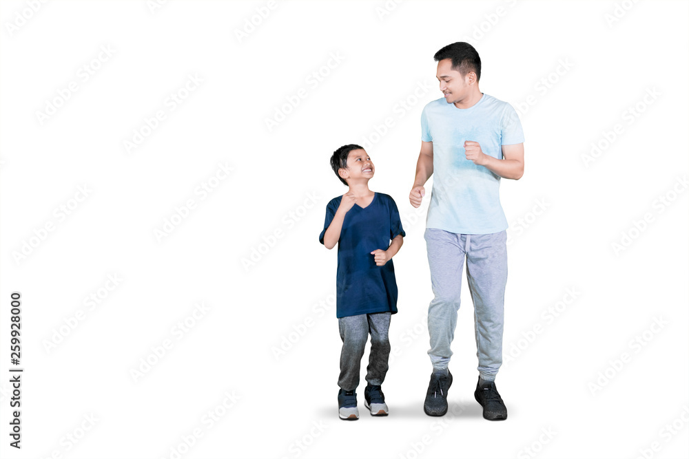 Young father doing exercise run with his son