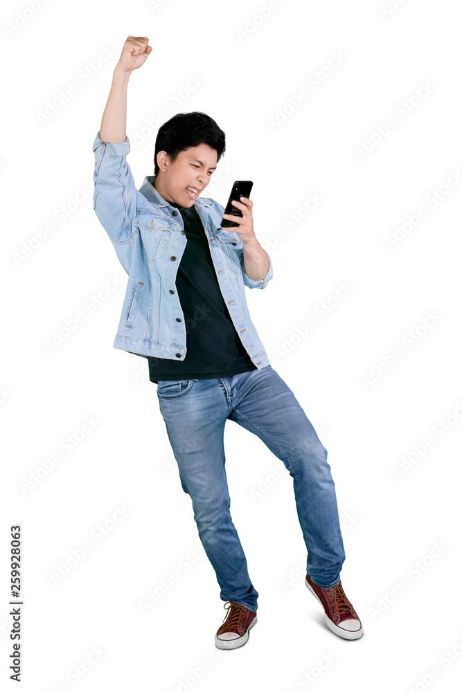 Young happy man holds a phone on studio Young happy man holds a phone on studio