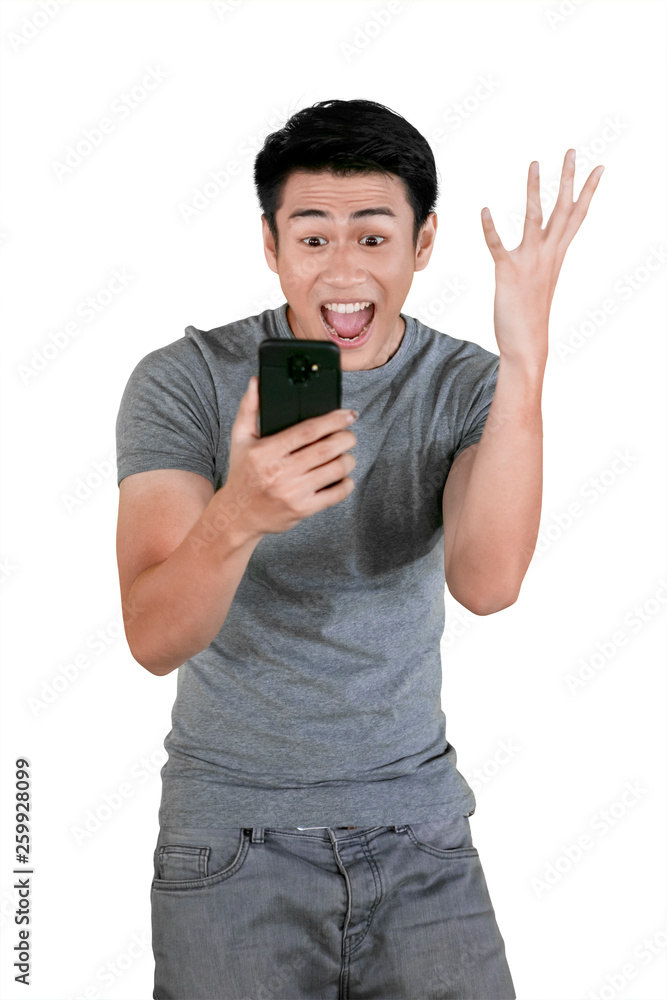 Young man expresses success during hold a phone
