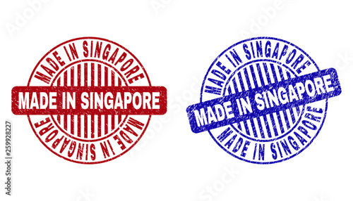 Grunge MADE IN SINGAPORE round stamp seals isolated on a white background. Round seals with grunge texture in red and blue colors.