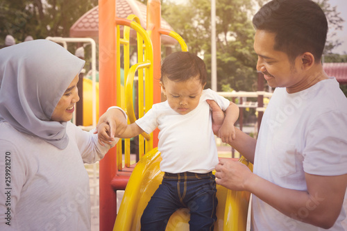 Young Muslim family playing in the playground © Creativa Images