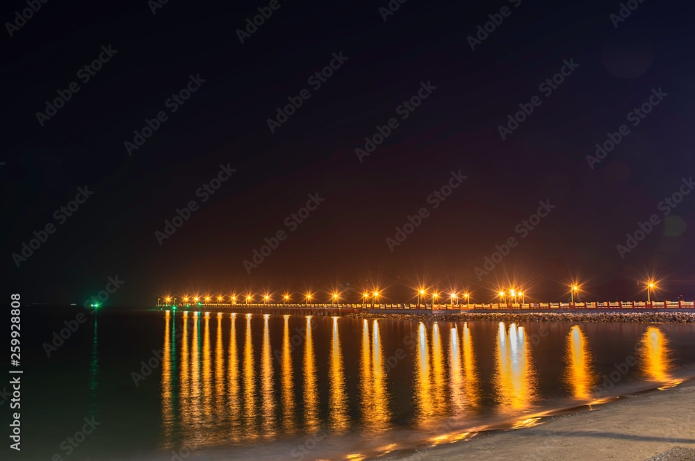 The lights on the bridge at night Background Sea  at Prachuap Bay in Thailand.