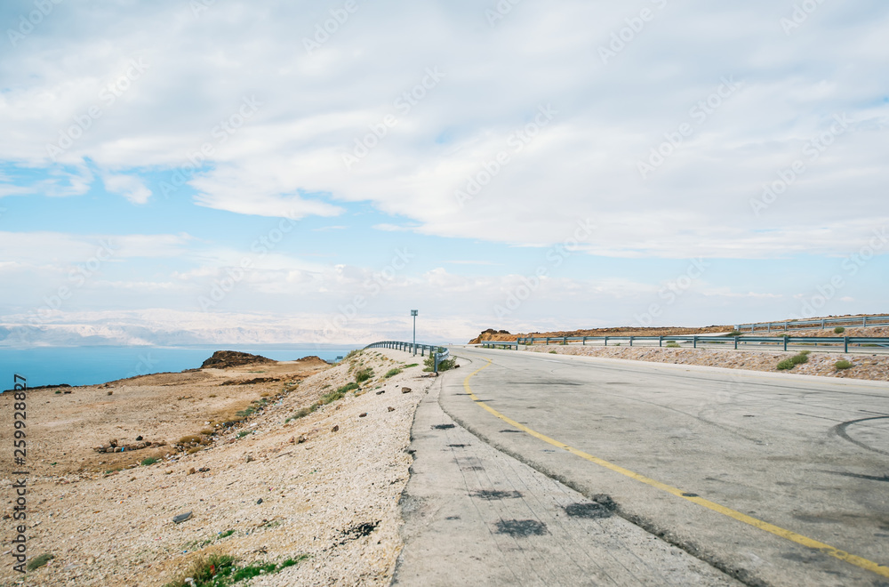 Roadside of the asphalt road along the coast of the Mertovy sea in Jordan