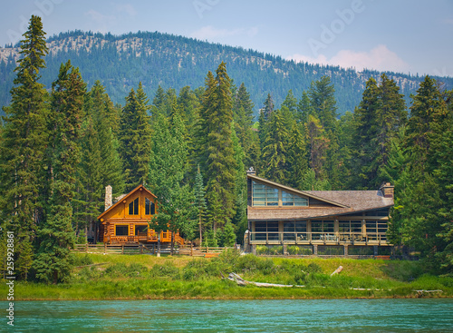 Two styles of wooden house commonly found near lakes and rivers. Rocky mountain ( Canadian Rockies ). Portrait, fine art. Near Calgary. Jasper and Banff National Park, Alberta, Canada: August 2, 2018