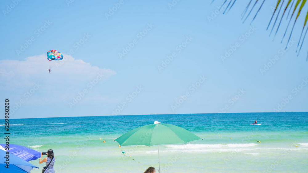 Tropical beach background with beautiful blue sea and parachute  , crystal clear sea and white sand with palms