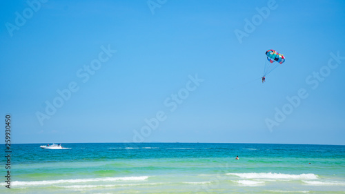 Tropical beach background with beautiful blue sea and parachute  , crystal clear sea and white sand with palms