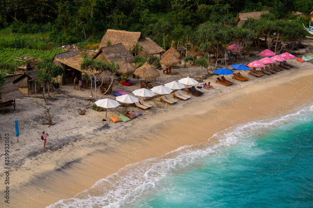 2018_1_19 Nusa Penisa, BALI. Aerial or Top view of colorful Atuh beach. Turquoise water, white sand beach, warm sunlight, sun loungers and parasols. Tourist popular destination/attraction in Indonesia 2018_1_19 Nusa Penisa, BALI. Aerial or Top view of colorful Atuh beach. Turquoise water, white sand beach, warm sunlight, sun loungers and parasols. Tourist popular destination/attraction in Indonesia