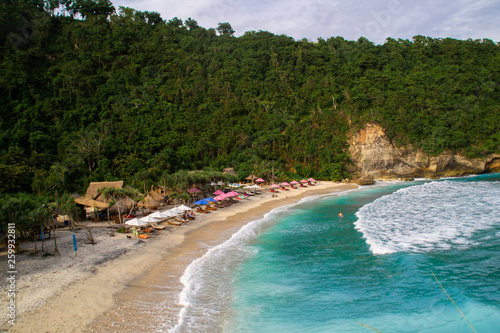 2018_1_19 Nusa Penisa  BALI. Aerial or Top view of colorful Atuh beach. Turquoise water  white sand beach  warm sunlight  sun loungers and parasols. Tourist popular destination attraction in Indonesia
