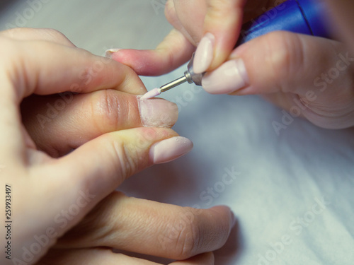 Remove cuticles in the beauty salon. Perfect nails manicure process. Hardware manicure