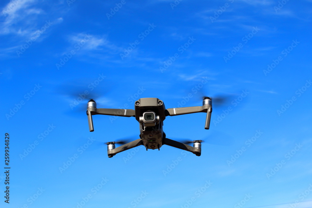 Flight of the drone against the blue sky. Flight of the drone against the blue sky.
