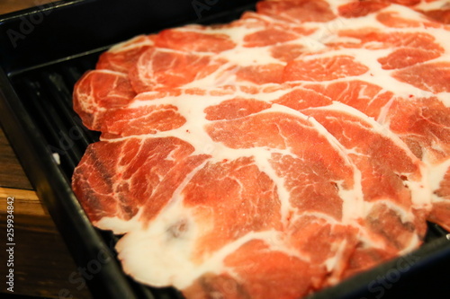 Raw beef sliced pieces on black plate for Yakiniku BBQ Japanese style.