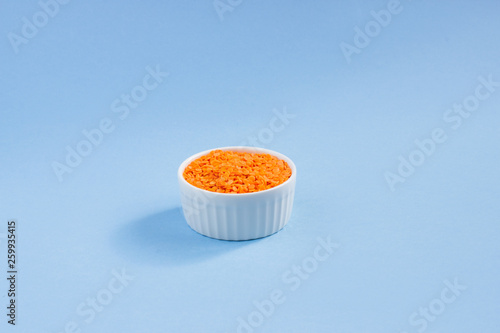 lentils in a plate on top  on a blue background  copy space