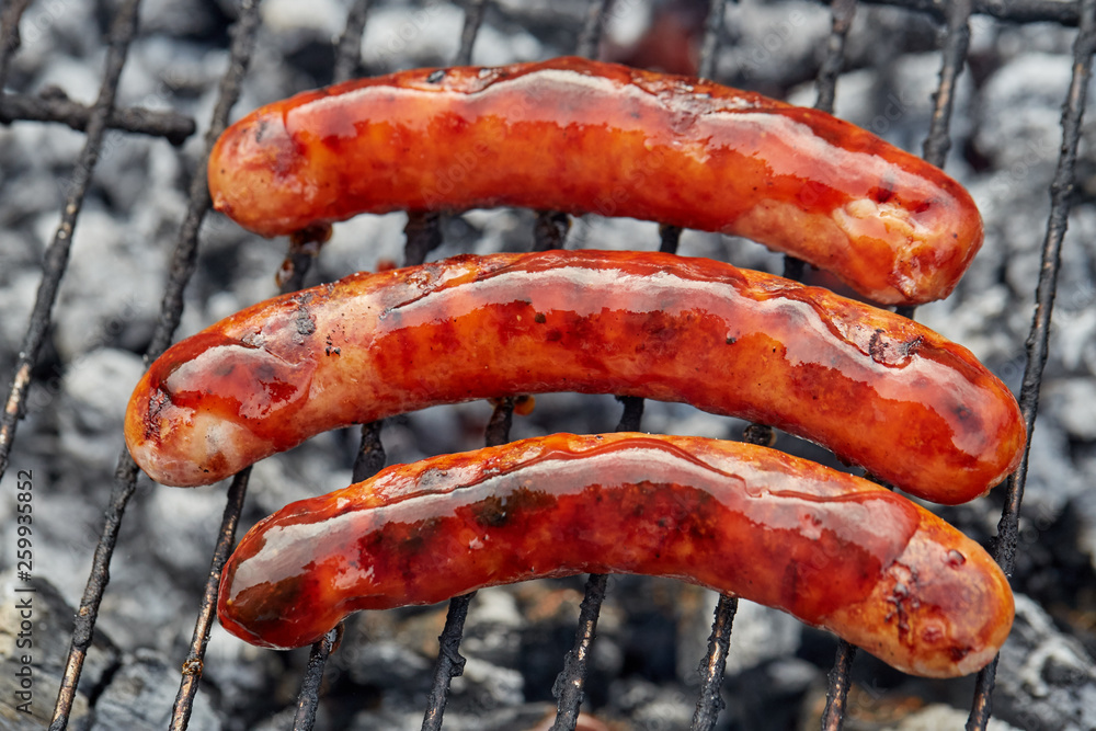 Fototapeta premium Closeup BBQ with fiery sausages on the grill