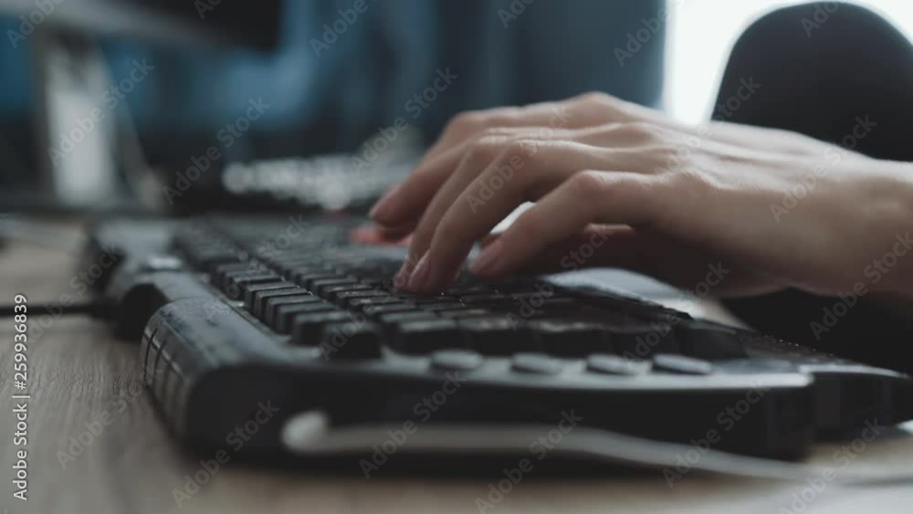 View of female hands typing on keyboard on blurred background View of female hands typing on keyboard on blurred background