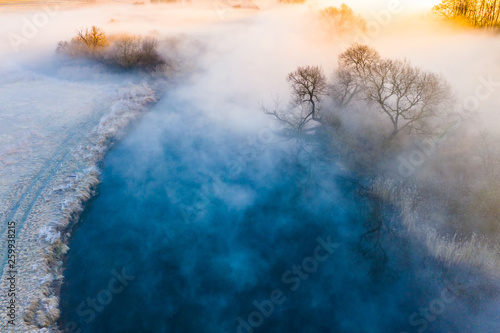 Amazing foggy landscape. Cold morning concept. River flowing in misty area