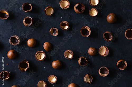 Top view of background texture of fresh natural shells of macadamia nuts, full frame and flat lay