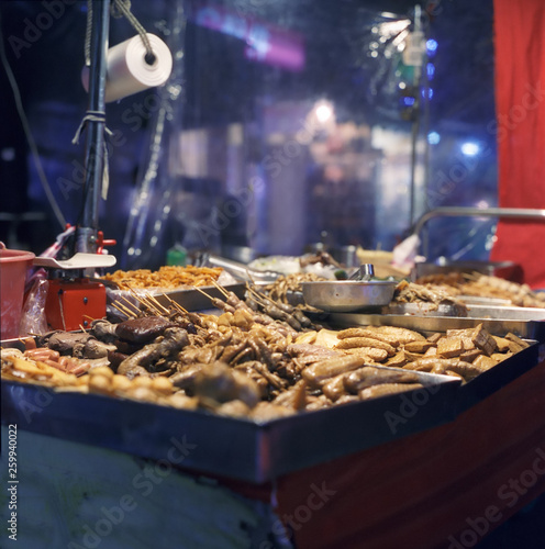 A food stall in a typical night market in Taipei with Tofu and chicken meat snacks