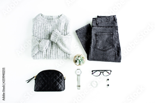 Women fashion clothes and accessories. Feminine youth collage on white background top view. Flat lay female style look with warm sweater, jeans, glasses. Top view.