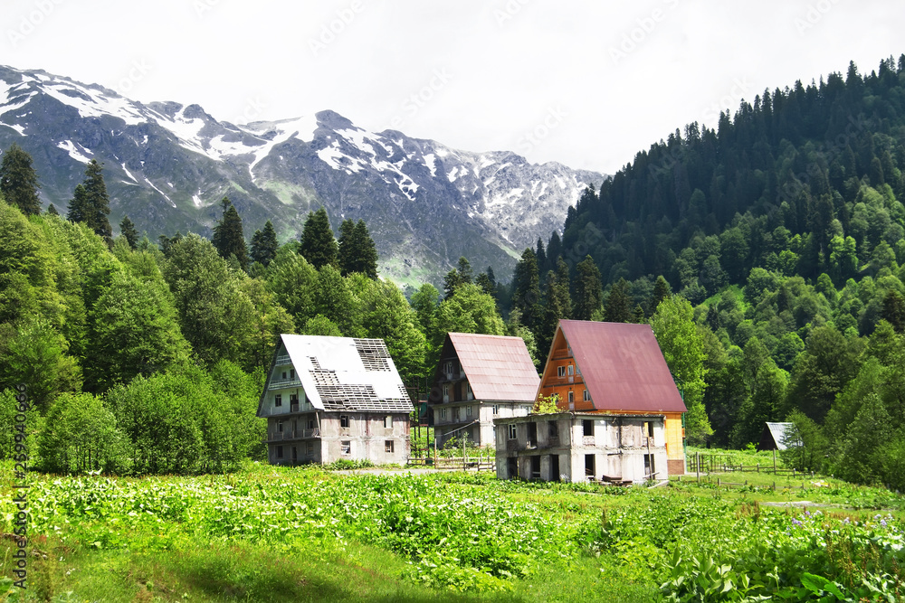 Old abandoned houses in Auadhara. Spring mountain landscape. Caucasus Mountains, Republic of Abkhazia.