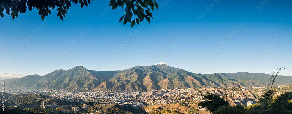 Panoramic aerial view of Caracas during a sunset - obrazy, fototapety, plakaty 