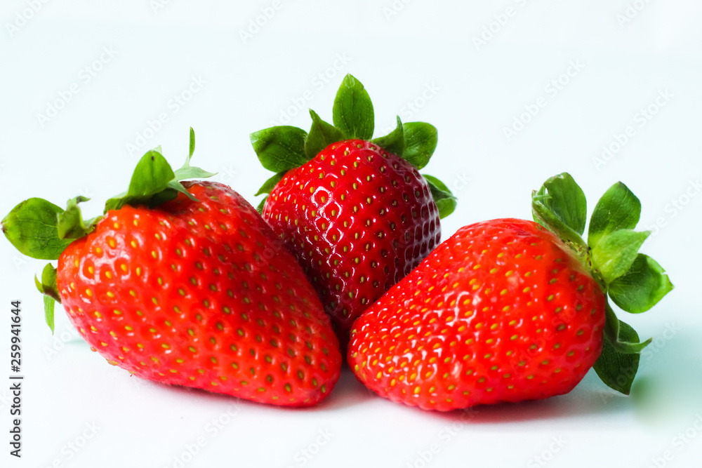 Group of fresh, juicy strawberries close up, selective focus, white background Group of fresh, juicy strawberries close up, selective focus, white background