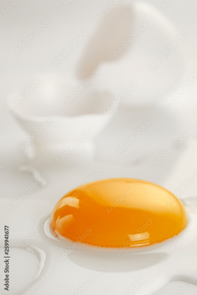 Broken egg on white background (selective focus) Broken egg on white background (selective focus)