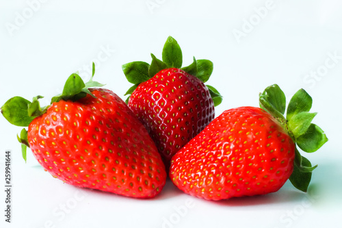 Group of fresh, juicy strawberries close up, selective focus, white background