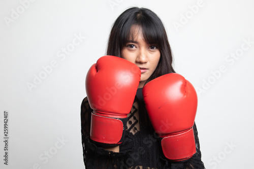 Young Asian woman with red boxing gloves.