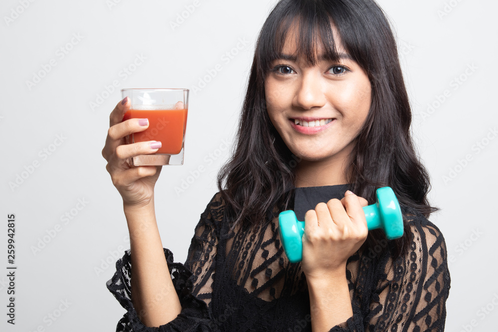 Healthy Asian woman with dumbbell and tomato juice. Healthy Asian woman with dumbbell and tomato juice.