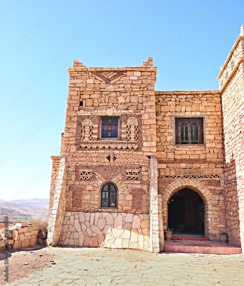 Beautiful House in the Atlas Mountains of Morocco, built of rough-cut pieces of red rock Beautiful House in the Atlas Mountains of Morocco, built of rough-cut pieces of red rock