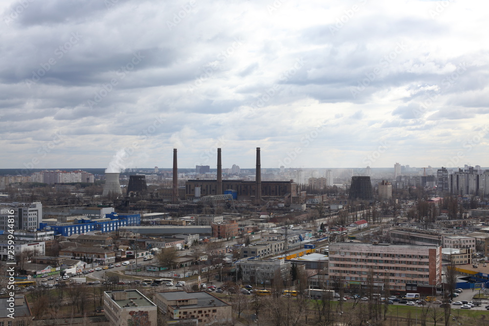 The aerial View of urban fringes in a cloudy day.View over the city rooftops at industrial suburb.Heating Power Plant,moderns buildings,uptown/Industrial cityscape