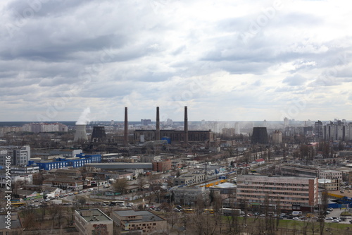 The aerial View of urban fringes in a cloudy day.View over the city rooftops at industrial suburb.Heating Power Plant moderns buildings uptown Industrial cityscape