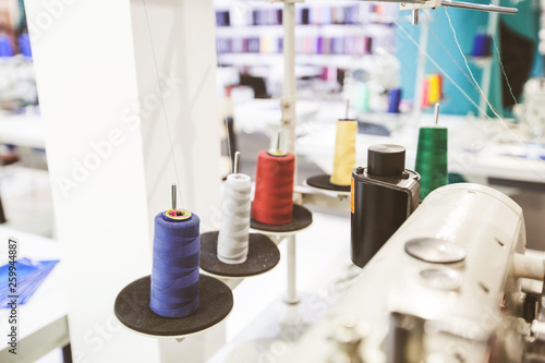 Colorful sewing threads spools at textile workshop