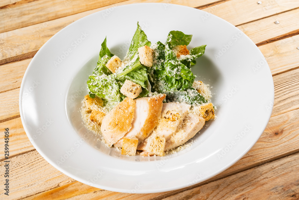 fresh caesar salad in the white plate fresh caesar salad in the white plate