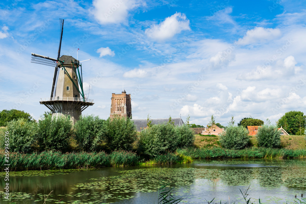 mill called Nooit Gedagt and church in fortified town Woudrichem, The Netherlands