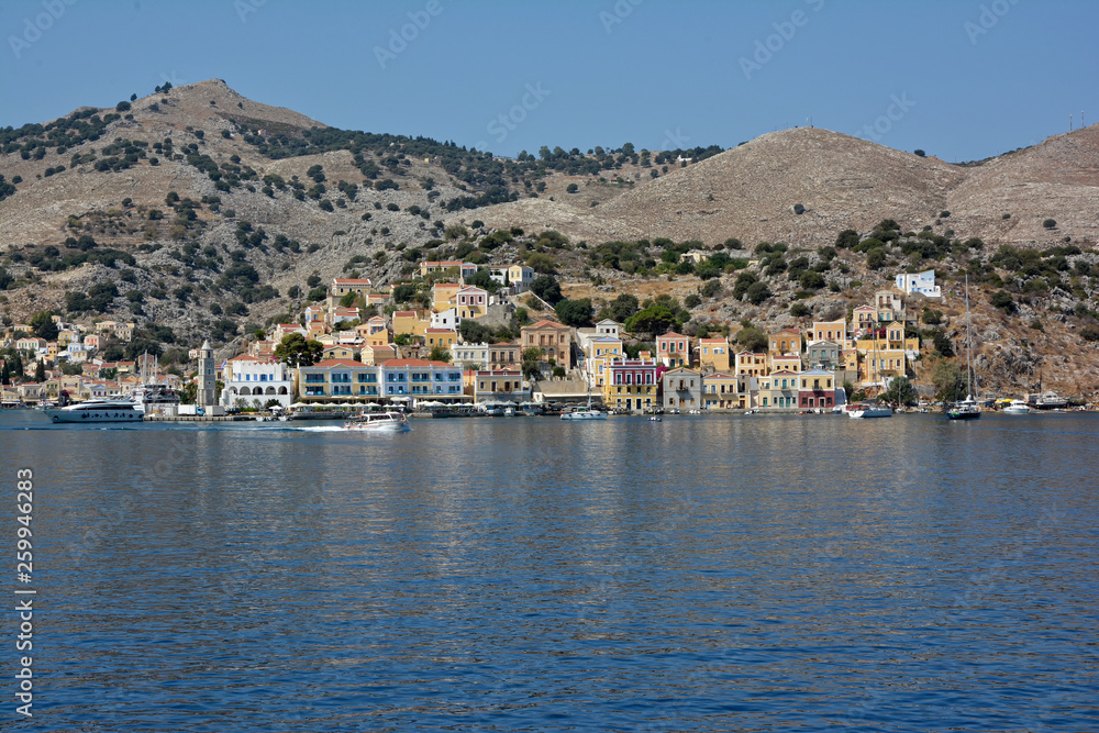 View of beautiful bay with colorful houses on the hillside of the island of Symi. Greece