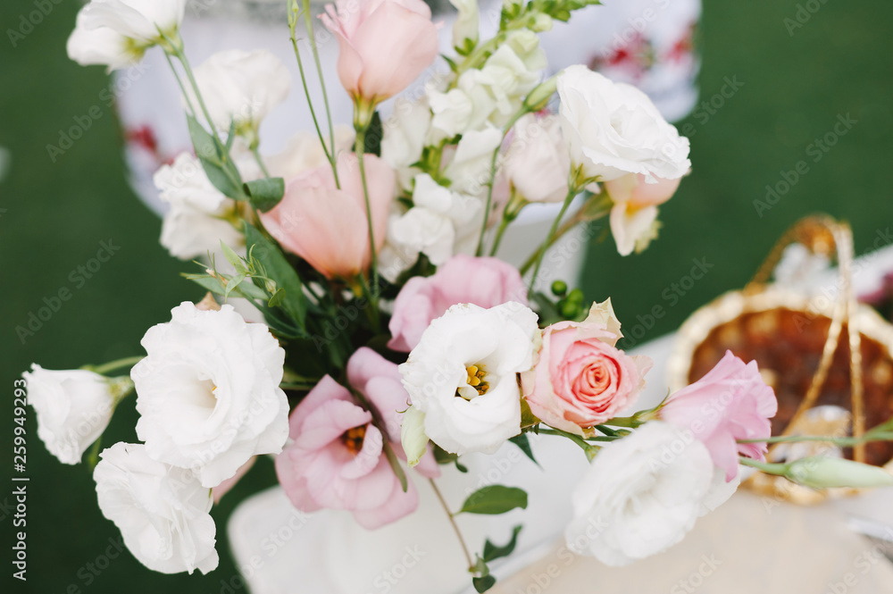 Beautiful and colorful bouqut of pink and white roses on wedding table Beautiful and colorful bouqut of pink and white roses on wedding table