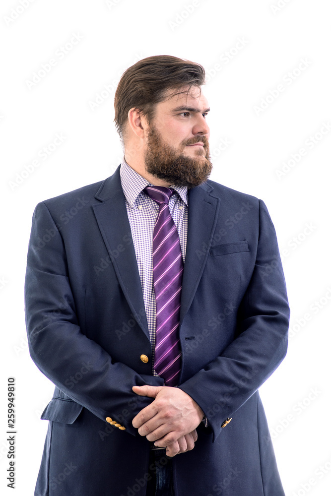 face profile portrait of a big handsome serious bearded business man in a dark suit, isolated on white