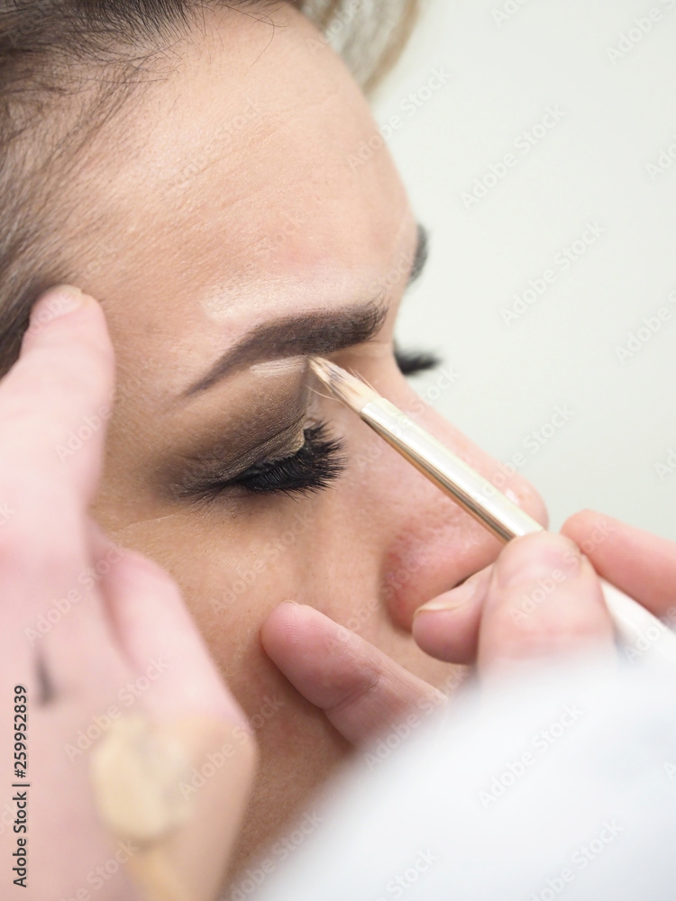 Female makeup with eyebrow pencil. Close up. 
