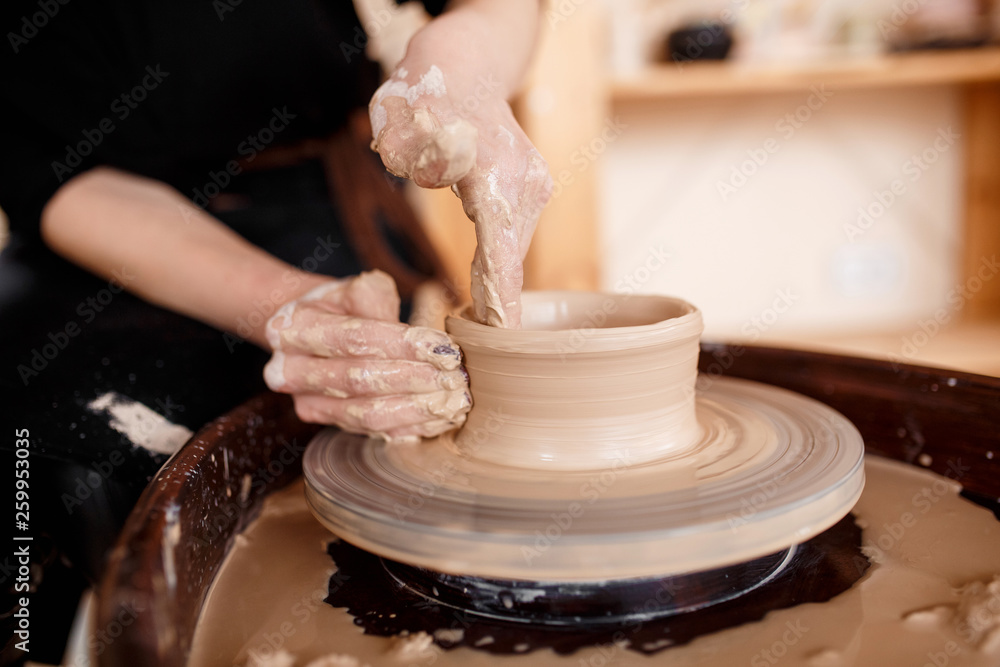 Hands sculpt new utensil on a pottery wheel Hands sculpt new utensil on a pottery wheel