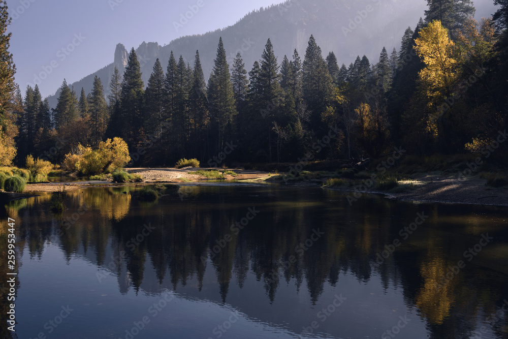 Autumn colors reflected in the Merced River in early morning light in Yosemite National Park